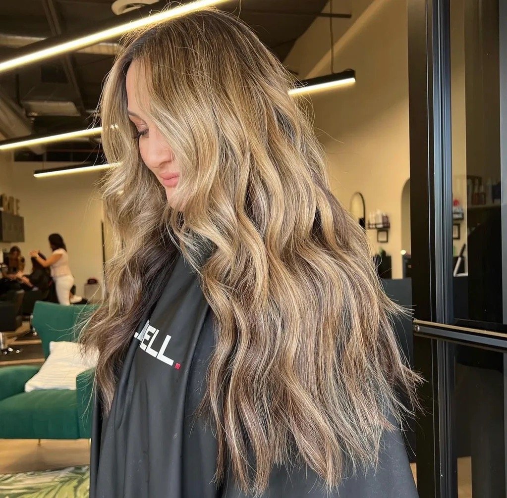 Beige blonde balayage with long layered waves and soft dimension in Chandler Arizona